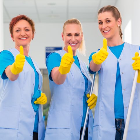 Cleaning ladies working in team showing the thumbs up sign