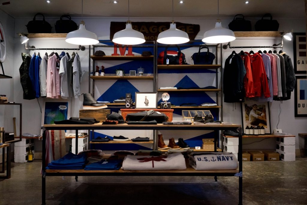 Image of a clothing shop with sweaters and shirts on display