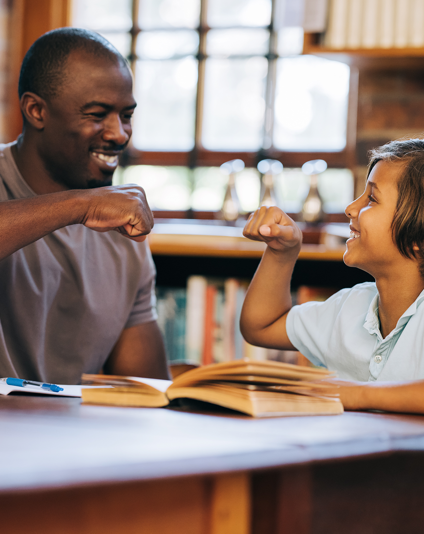 teacher and student celebrating an accomplishment